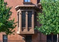 An old bay window with cornice and leaded glass in Cobble Hill, Brookyn, NYC