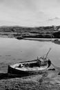 Old beached fishing boat on Irish beach in black and white