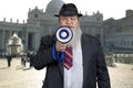 Old bearded businessman making an announcement in megaphone. Royalty Free Stock Photo