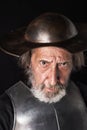 Old bearded man with breastplate and helmet