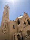 The old beautiful beige white stone orthodox Christian church is a place for praying to God with a cross with windows and twins in Royalty Free Stock Photo