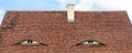 Old beautiful european german fachwerk building rooftop with eye shaped windows and chimney. Typical traditional ancoent Royalty Free Stock Photo