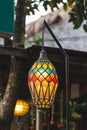 Old beautiful hanging lamp outside in cafe garden made from stained glass