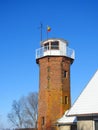 Old red bricks lighthouse near Atmata river, Lithuania Royalty Free Stock Photo