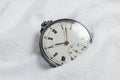 Old beautiful pocket watch lying in the beach sand Royalty Free Stock Photo