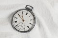 Old beautiful pocket watch lying in the beach sand Royalty Free Stock Photo