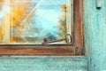 An old beautiful rusty key is lying on the window of an old house. Royalty Free Stock Photo