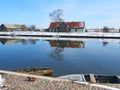 Homes and ships in river Minija in winter , Lithuania Royalty Free Stock Photo