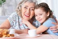 Old woman with a young girl drinking tea Royalty Free Stock Photo