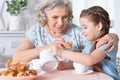 Old woman with a young girl drinking tea Royalty Free Stock Photo