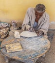 Old Bedouin man work handmade specific traditional stone objects. Luxor, Egypt