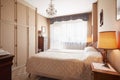 Old bedroom with queen size bed in cozy house Royalty Free Stock Photo