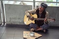 Old beggar play guitar for money donation