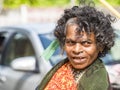 Old begging poor woman on the street of village