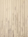 Old beige grungy paint blisters on vertical wooden planks