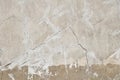 Old beige pink painted plaster wall with cracks