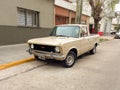 old beige 1970s Fiat 125 pickup parked in the street. Classic small utility car built in Argentina