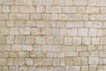 Old beige stone wall background texture