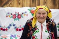 An old Belarusian or Ukrainian woman in an embroidered shirt. Slavic elderly woman in national ethnic clothes