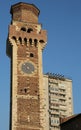 Old bell tower with clock of an ancient Italian basilica and the Royalty Free Stock Photo