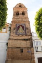 Old bell tower decorated with tiles with the image of the Virgin Mary of Ntra. Sra. de la Paz, in the town of Medina Sidonia