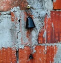 Old bell used on catle hanging on wall