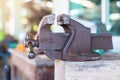 Old bench vise on workbench in workshop. Vintage Bench Vise Royalty Free Stock Photo