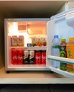 Old beverage cans and bottles inside mini hotel fridge Royalty Free Stock Photo