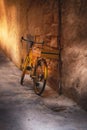 Old bicycle against wall in alley Royalty Free Stock Photo