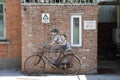 Old bicycle on brick wall with graffiti art of two kids in Beijing city, China Royalty Free Stock Photo