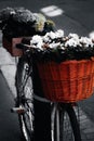 An old bicycle decorated with baskets of flowers