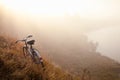 An old bicycle early in the morning in countryside and landscape mist. Royalty Free Stock Photo