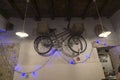 Old bicycle hanging on the wall with Christmas lights and chandeliers Royalty Free Stock Photo