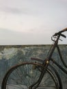 an old bicycle that has not been used for a long time and has begun to rust in the rain