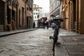 Old bicycle parked in a street of an italian city, people in the background Royalty Free Stock Photo