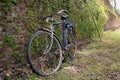 An old bicycle leaning against one of the old brick walls of the