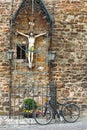 Old bicycle leaning against a statue of  statue of Jesus Christ at city Aachen, Germany Royalty Free Stock Photo