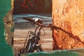 Old bicycle leaning on the worn wall