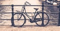 Old bicycle locked on a bridge over water canal, Amsterdam, Netherlands Royalty Free Stock Photo