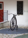 Old bicycle with one big and one small wheel in the yard in the old city, Tallinn