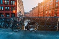 Old bicycle parked against iron hand railing on bridge in Hamburg warehouse district Royalty Free Stock Photo