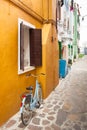 old bicycle parked long an external wall in Burano island, Venice Royalty Free Stock Photo