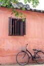 Old bicycle parked near house wall