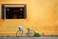 Old bicycle parked near house wall