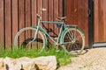 Old bicycle parked at a wooden fence, countrycide landscape