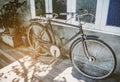 Old bicycle rusty park at loft wall of house vintage tone.