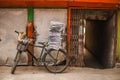 Old bicycle with stack of newspapers near rustic wall Royalty Free Stock Photo