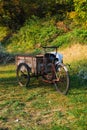Old bicycle with three wheels used to transport freshly picked o
