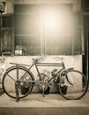 Old bicycle on wooden window house wall Royalty Free Stock Photo