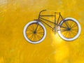 Old bicycle and yellow cement wall Royalty Free Stock Photo